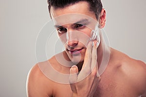 Man applying facial cream
