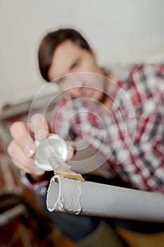 Man applying glue to end pvc pipe