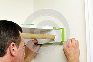 Man Applying Green Painter's Tape