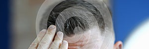 Man applying hair gel to his hair closeup