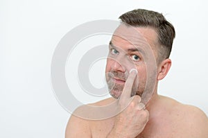 Man applying moisturizer to his skin