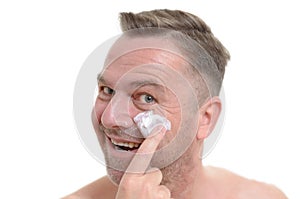 Man applying moisturizer to his skin