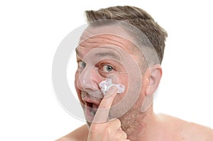 Man applying moisturizer to his skin