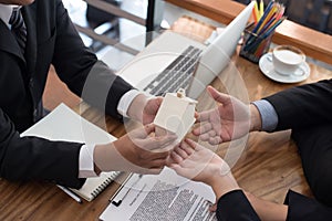 man applying for mortgage loan with bank employee. client signing contract document with realtor at real estate agency.