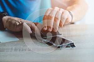 Man applying protective screen protector