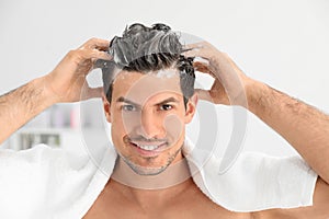 Man applying shampoo onto his hair