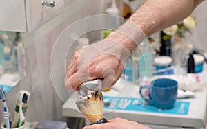 Man applying shaving foam to a brush