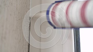 Man applying silicone sealant with caulking gun