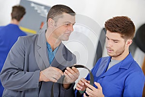 Man with apprentice holding bearing