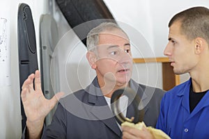 Man with apprentice holding bearing