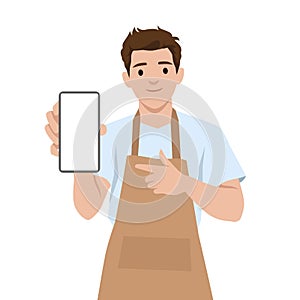 Man in Apron confidently holds and points at a blank smartphone screen