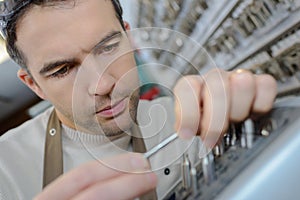 Man in apron making duplicates keys