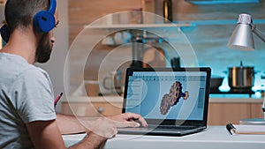 Man architect with wireless headset using laptop