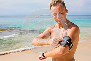 Man with arm band for mobile phone