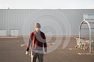 A man armed with a knife stands in the parking lot