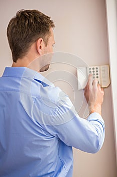 Man arming a home alarm