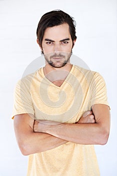 Man, arms crossed and serious fashion portrait isolated on a white background with mockup space. Face of male Europe