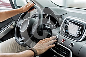 Man arms holding helm in automobile