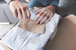 Man arms untying letter on clothes