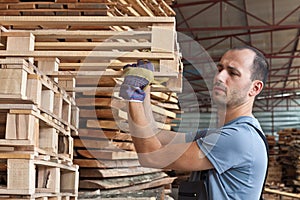 Man arraging pallets, horizontal shot