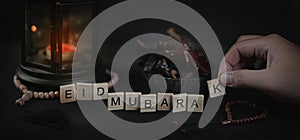 Man Arranging Eid Mubarak Greeting Scrabble Letters. Ramadan Can photo