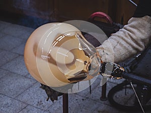 Man artists hands working on a Blown Glass Piece. Shaping glass bowl photo