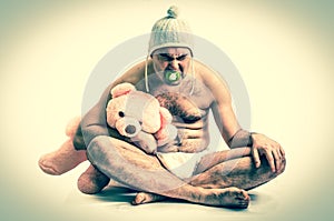 Man as baby. Child in diaper with pink teddy bear - retro style.