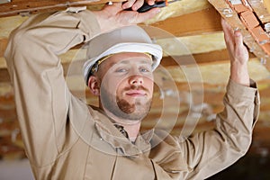 Man as builder carrying wood and working