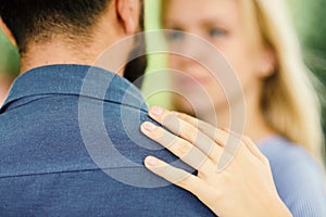 Man as support and protection for woman. Girl hugs bearded man, put hand on his shoulder.