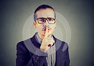 Man asking for silence with finger on lips gesture