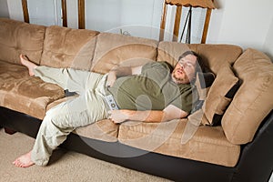 Man asleep on the couch photo