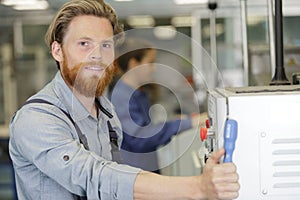 man assembles electronic components on machine