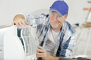 man assembling air conditioning unit