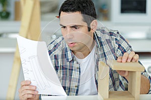 man assembling furniture close up