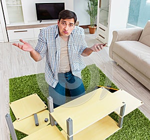 Man assembling furniture at home