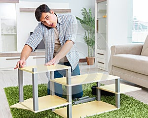 Man assembling furniture at home