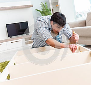 Man assembling furniture at home