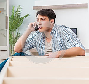 Man assembling furniture at home