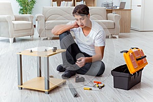 The man assembling furniture at home