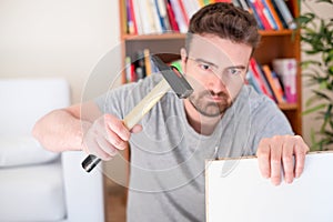 Man assembling furniture at home on the floor