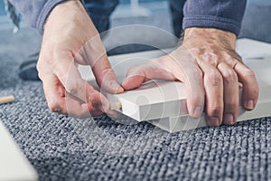 Man assembling furniture at home, hand with wooden dowel pins