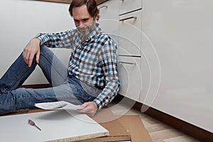 Man assembling the kitchen furniture