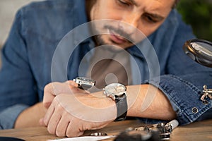 man assembling mechanical watch