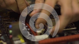 Man assembling motherboard. Close-Up.