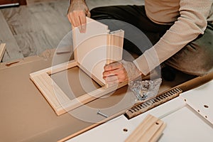 A man assembling new furniture bought for home