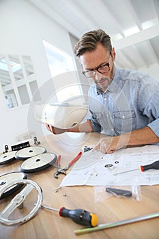 Man assembling a toy car for his child