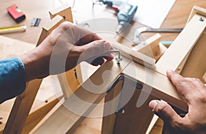 Man assembly wooden furniture,fixing or repairing house with screwdriver tool.modern living concepts