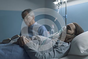 Man assisting a young woman at the hospital