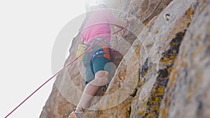 Man athlete climbing on the high rock