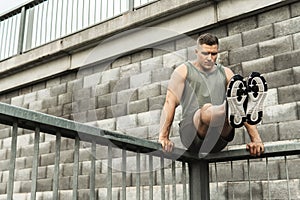 Man athlete doing L-sit exercise during his calisthenics workout